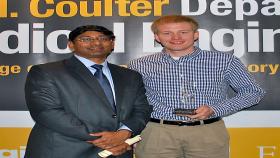 Andy Kolpitcke, right, is greeted by Coulter Department Chair Ravi Bellamkonda after getting his BME Leadership Award for Outstanding Industrial Work Experience.