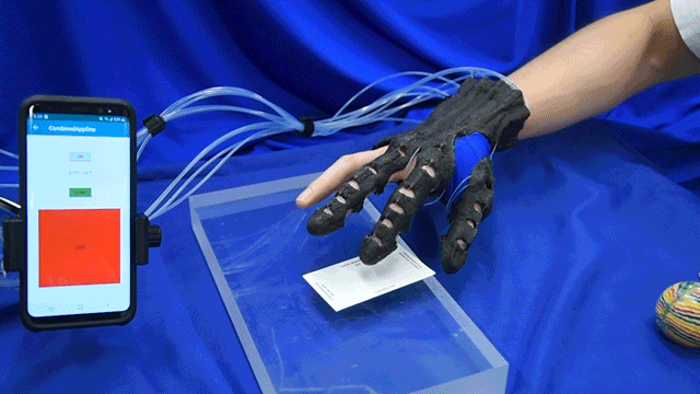 Hand exoskeleton picking up a card