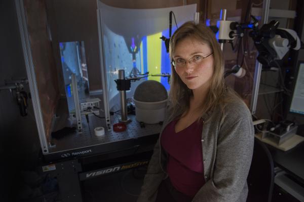 Annabelle Singer, assistant professor in the Wallace H. Coulter Department of Biomedical Engineering, studies how the hippocampus’ neurons fire as the brain creates orientation in a video maze seen in the background. Photo: Georgia Tech / Christopher Moore