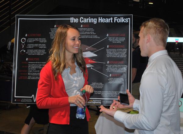 Alexandra Ricard and Christopher Boyd of Caring Heart Folks discuss their Capstone Design project during Tuesday night's Expo in McCamish Pavillion.
