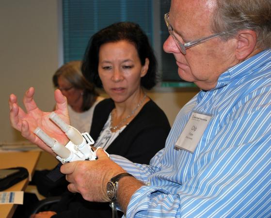 APDC executive committee members Charles Frame and Traci Leong check out one of the devices submitted for consideration at the innovation competition.