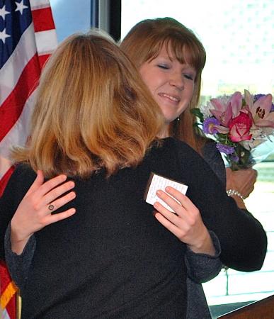 Elizabeth Carpenter (right) hugs Barbara Fasse, winner of the Outstanding Committment to Teaching Award.