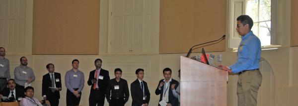 A long line of researchers waits their turn at the podium during rapid fire presentations.