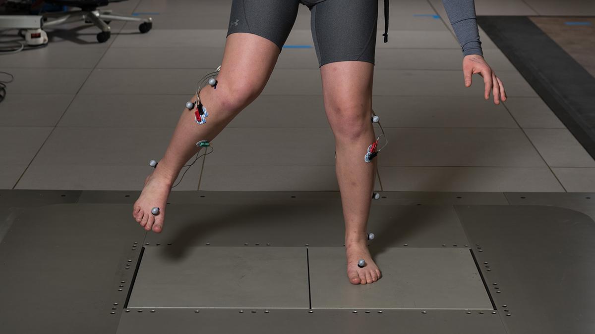 A study subject works to regain balance on a shifting floor in Lena Ting's lab. Ting’s research team uses this shifting floor to literally pull the rug out from under people to study balance and brain activity. (Photo: Rob Felt)