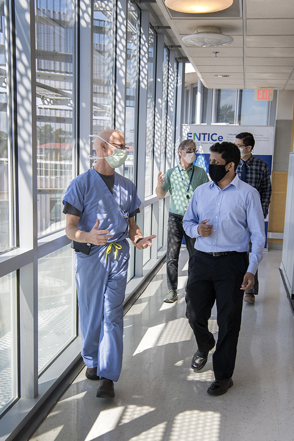 This group of clinicians and scientists will collaborate with Chethan Pandarinath, front right, on a $2.4 million, five-year project using artificial intelligence tools to revolutionize the speed and accuracy of brain-machine interfaces. The team includes Robert Gross, front left, a functional neurosurgeon; Jonathan Glass, back left, a neurologist and director of Emory's ALS Center; and Nicholas Au Yong, also a functional neurosurgeon. (Photo: Jack Kearse)