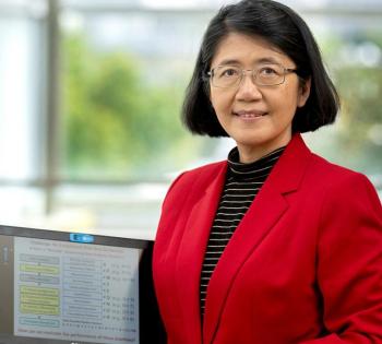 May Wang with a laptop showing some of her data.