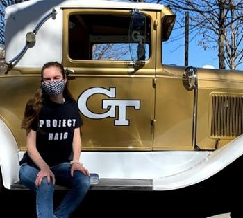 Brady Bove sits on the running board of the Ramblin Wreck.