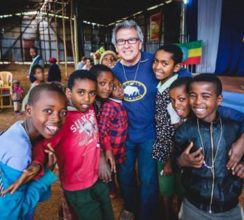 Rudy Gleason in Ethiopia with a group of children.