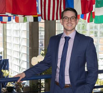 PJ Jarquin stands in what's colloquially known as the Flag Building, with flags from around the world hung from the ceiling. 