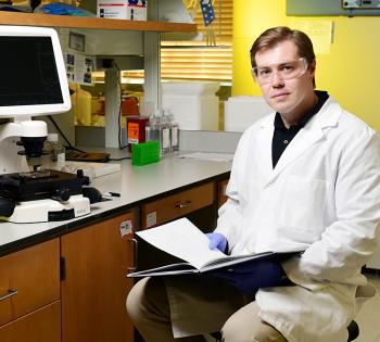Denis Tsygankov sitting in his lab