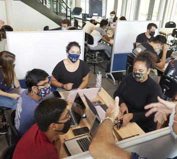 Professors of the Practice James Rains, back left, and James Stubbs talk with students about their Capstone Design projects during one of the first classes held in Coulter BME’s new Design Garden space. The collaboration and innovation space is open to biomedical engineering students 24/7 whenever classes aren’t using it. The space opened in August 2021. (Photo: Craig Bromley)