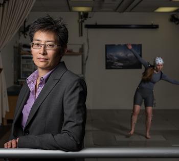 Lena Ting in her lab with a subject in the background. (Photo: Rob Felt)