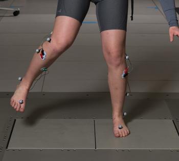 A study subject works to regain balance on a shifting floor in Lena Ting's lab. Ting’s research team uses this shifting floor to literally pull the rug out from under people to study balance and brain activity. (Photo: Rob Felt)