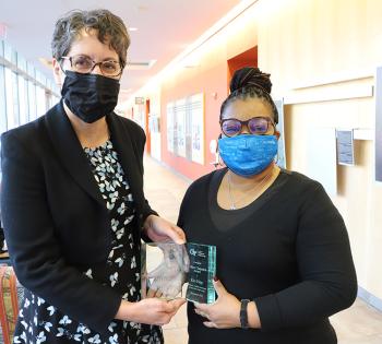 Kim Paige, right, accepts a Georgia Tech College of Engineering 2021 Culture Champion Award from Coulter Department Chair Machelle Pardue. (Photo: Joshua Stewart)