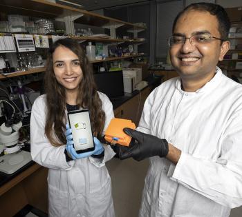 Postdoctoral fellow Neda Rafat and Assistant Professor Aniruddh Sarkar with the Bluetooth reader and smartphone app their team developed to display test results from a new electronic Covid-19 test chip. (Photo: Candler Hobbs)