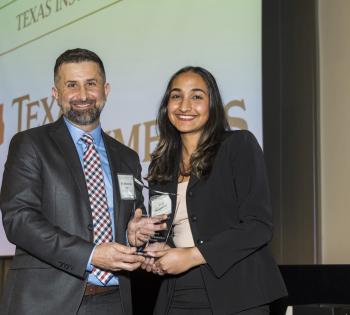 Photo of Sriya Surapaneni holding the Helen Grenga Award Along with BME Senior Academic Professional, Essy Behravesh