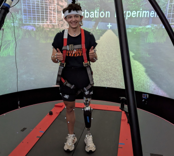 Photo of BME student Nathan Wallace testing out a special prosthetic leg