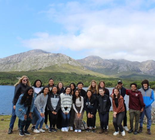 Photo of a group of Coulter BME students, male and female, standing in front of a lake in Galway, Ireland with mountains in the background.