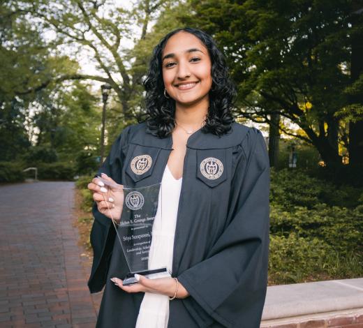 Photo of Sriya Surapaneni, an alumni who earned the Helen Grenga Award, in her graduation regalia