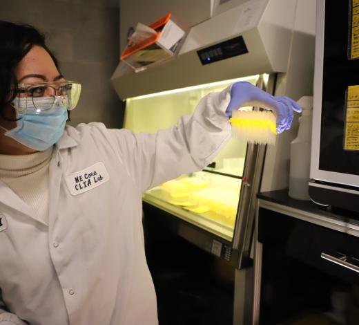 Photo of a female BME student holding up a tester for sanitized pipettes as part of Georgia Tech's Tip Cycle program