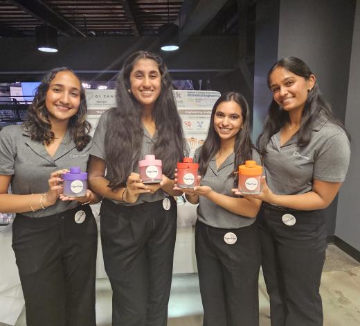 Photo of BME Capstone group holding their device at the fall 2024 COE Capstone Expo