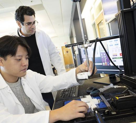 Photo of two researchers from Coulter BME looking at computer imaging of glioblastomas.