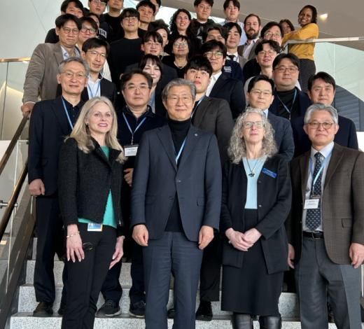 Group photo of faculty and students from Yonsei University and Coulter BME standing on steps inside the Emory University HSRB II building.