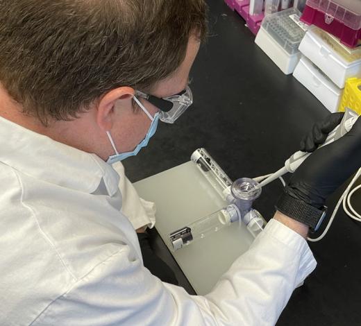 Researcher Daryll Vanover works with the nebulizer he adapted to test a new mRNA-based treatment for flu and Covid-19. The team used mRNA technology to code for a protein called Cas13a that destroys parts of the RNA genetic code that viruses use to replicate in cells in the lungs. It was developed by researchers in Philip Santangelo’s lab in the Wallace H. Coulter Department of Biomedical Engineering. (Photo Courtesy: Daryll Vanover)