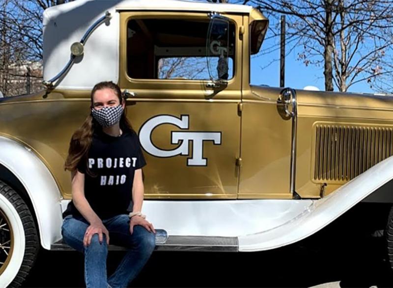 Brady Bove sits on the running board of the Ramblin Wreck.