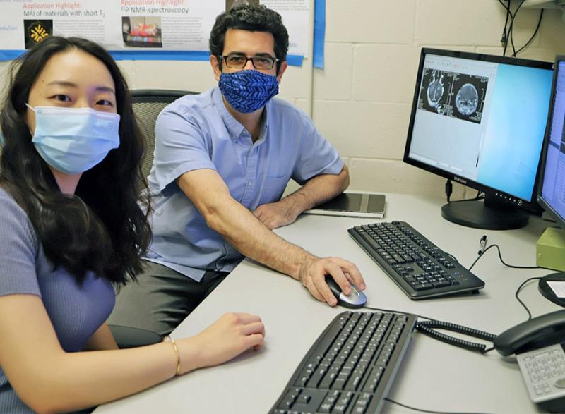 Yutong Guo and Costas Arvanitis sitting at a computer