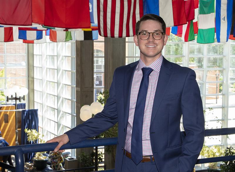 PJ Jarquin stands in what's colloquially known as the Flag Building, with flags from around the world hung from the ceiling. 