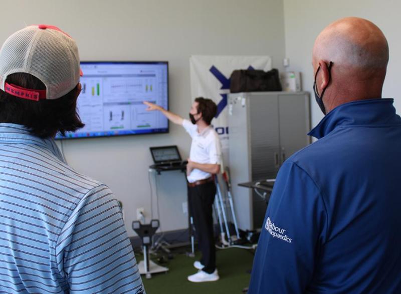 Second-year mechanical engineering student Brittan Pero talks through some of the data collected during tests of a 3D-printed putter with Tech alumni Reagan Cink, left, and his father, Stewart, a PGA Tour pro golfer. Pero joined the project this summer to help with testing and build on the design created by biomedical engineering student Caroline Means. (Photo: Joshua Stewart)