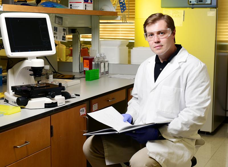Denis Tsygankov sitting in his lab