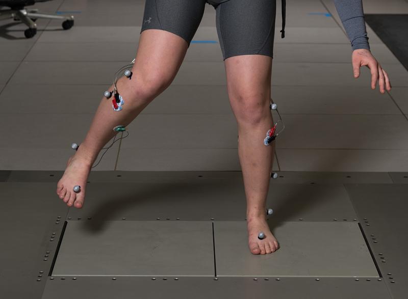 A study subject works to regain balance on a shifting floor in Lena Ting's lab. Ting’s research team uses this shifting floor to literally pull the rug out from under people to study balance and brain activity. (Photo: Rob Felt)