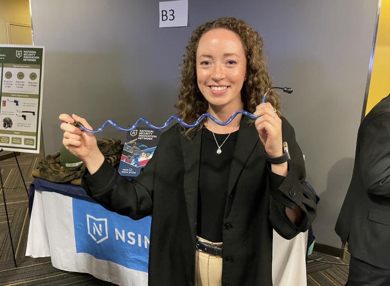 Senior BME student holding a device her group designed for Georgia Tech's Capstone Expo in April 2023
