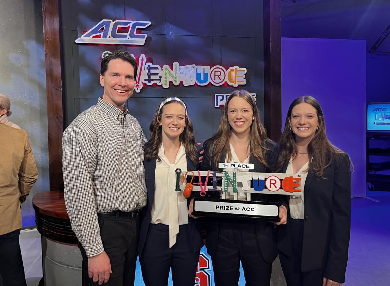Photo of Neurochamp team members holding ACC InVenture Prize plaque