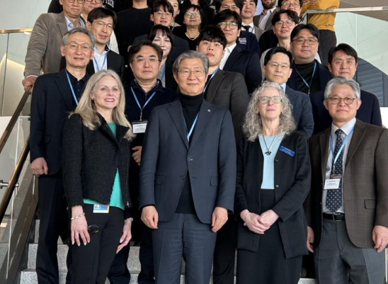Group photo of faculty and students from Yonsei University and Coulter BME standing on steps inside the Emory University HSRB II building.