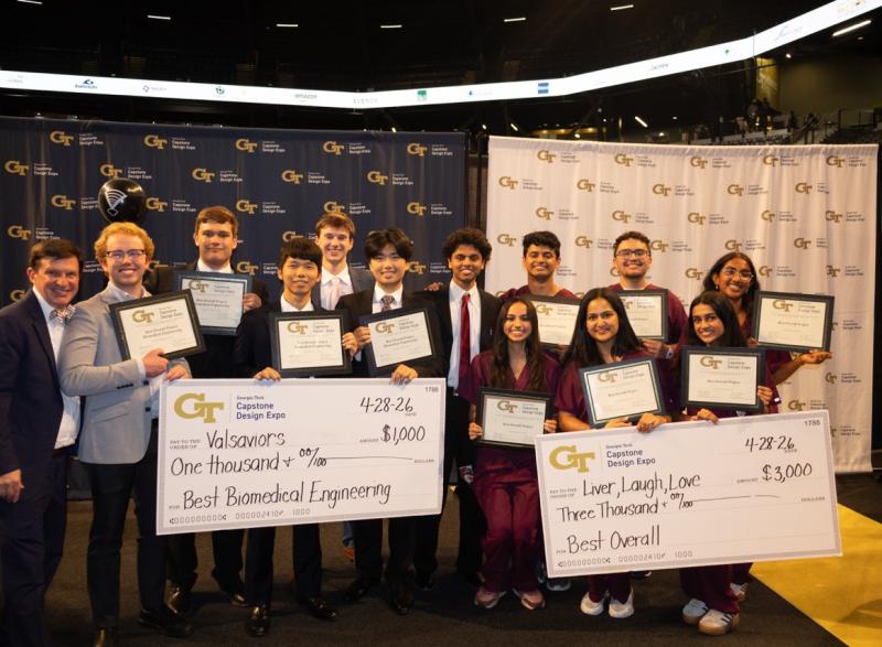 Group photo of Coulter BME Capstone teams. On the far left side of the photo stands Chris Rovell, Profeesor of the Practice and one of the faculty advisors for the BME capstone program. (left to right): Team Valsaviors and Team Liver, Laugh, Love. 