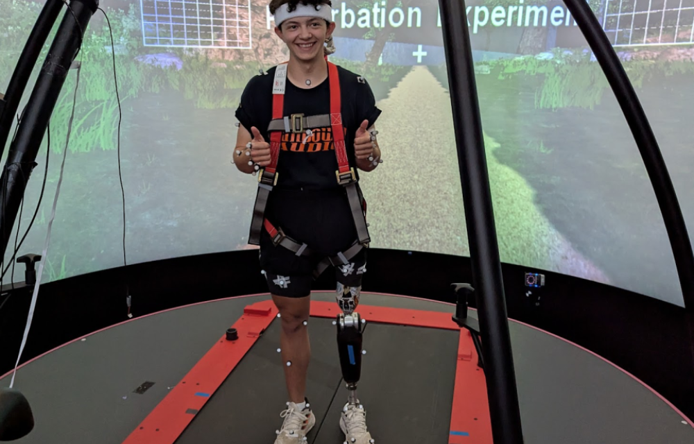 Photo of BME student Nathan Wallace testing out a special prosthetic leg