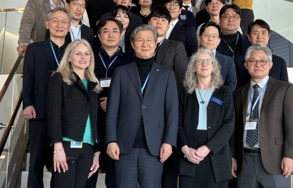 Group photo of faculty and students from Yonsei University and Coulter BME standing on steps inside the Emory University HSRB II building.